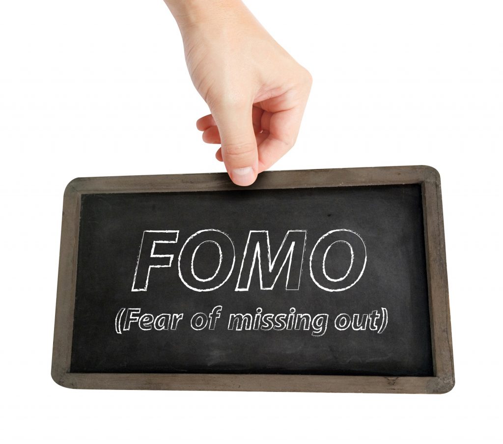 FOMO written on chalkboard